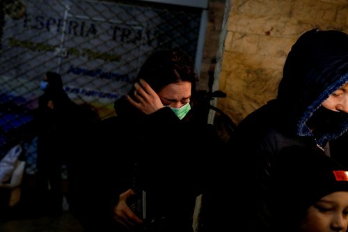 A woman reacts as she arrives in Athens after fleeing Russia's military operation against Ukraine, in Athens