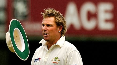 FILE PHOTO: Australia's Warne juggles hat on third day of first test of The Ashes series at Lords.