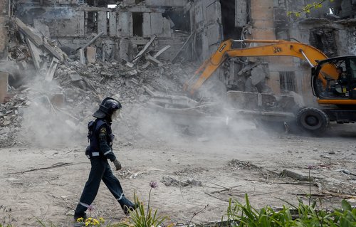 Rescuers remove debris of a destroyed residential building in Mariupol