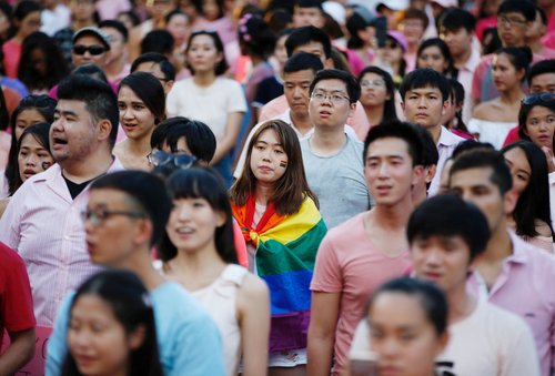 FILE PHOTO: A woman wrapped in the rainbow flag is seen at the Pink Dot rally, Singapore's annual gay pride rally, in Singapore