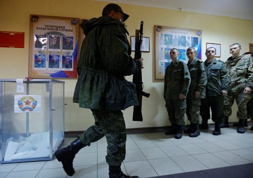 Service members of the self-proclaimed Luhansk People's Republic vote during a referendum in Luhansk