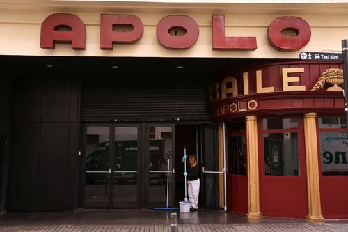 A cleaner is seen outside Apolo, a Barcelona concert hall and night club. Staff from the Apolo found the body of a young man on Wednesday whom the police identified as Australian rugby player Liam Hampson