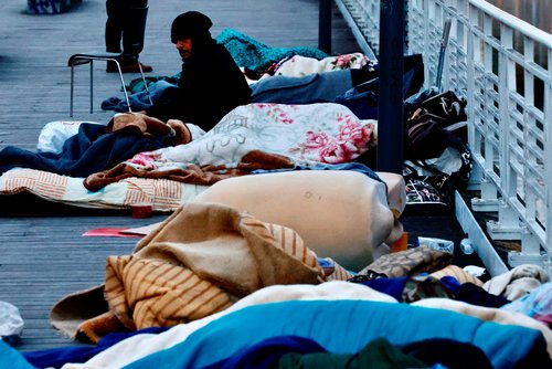 Asylum seekers sleep on a street in central Brussels