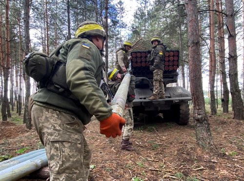 Ukrainian servicemen fire with a BM21 Grad multiple launch rocket system in a frontline on the border of Kharkiv and Luhansk regions