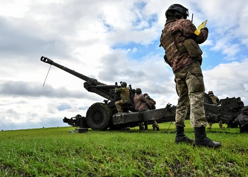 Ukrainian service members prepare to shoot from a towed howitzer at a front line in Zaporizhzhia Region
