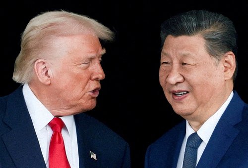 FILE PHOTO: President Donald Trump and Chinese President Xi Jinping talk as they leave after a bilateral meeting at Gimhae International Airport