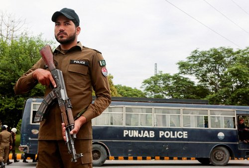 FILE PHOTO: A police officer stands guard on a road leading to