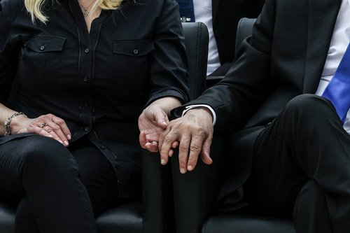 Israel’s Prime Minister Benjamin Netanyahu holds the hand of his