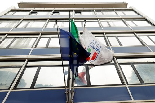 The flags of Italy and of the Italian Football Federation (FIGC) wave on the exterior o