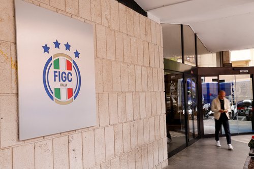 A man passes by the entrance of the Italian Football Federation (FIGC) headquarters,
