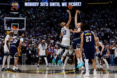 Apr 27, 2026; Denver, Colorado, USA; Minnesota Timberwolves center Rudy Gobert (27) wins the tip off against Denver Nuggets center Nikola Jokic (15) as guard Jamal Murray (27) looks on in the first quarter during game five of the first round of the 2026 N