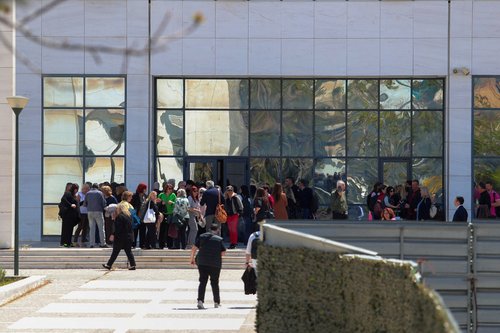 People gather outside the Athens’ Court of Appeal following a shooting incident
