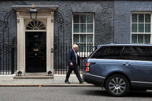 Britain's Prime Minister Boris Johnson walks outside Downing Street in London