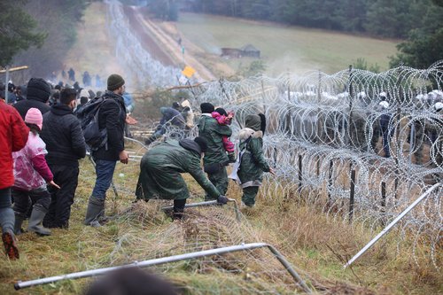 Migrants gather on the Belarusian-Polish border
