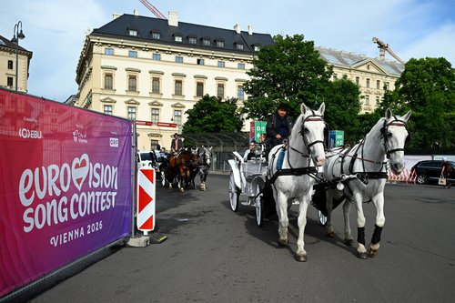 A Viennese Fiaker carriage passes by a barrier of the Eurovision fan zone in Vienna, Austria, May 11, 2026. REUTERS/Elisabeth Mandl