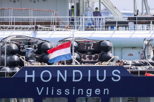 People in personal protective suits on board the cruise ship MV Hondius