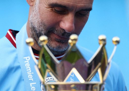 FILE PHOTO: Soccer Football - Premier League - Manchester City v Chelsea - Etihad Stadium, Manchester, Britain - May 21, 2023 Manchester City manager Pep Guardiola celebrates with the trophy after winning the Premier League REUTERS/Carl Recine/File Photo