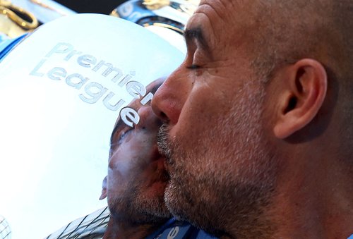 FILE PHOTO: Soccer Football - Premier League - Manchester City v West Ham United - Etihad Stadium, Manchester, Britain - May 19, 2024 Manchester City manager Pep Guardiola kisses the trophy after winning the Premier League Action Images via Reuters/Lee S