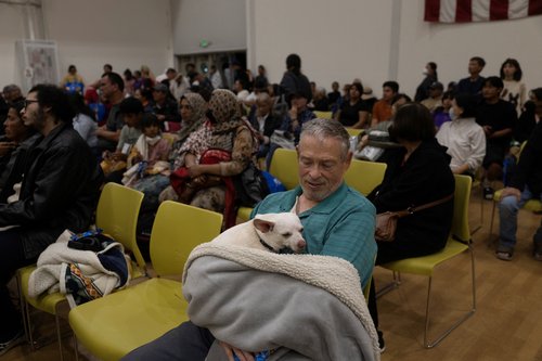 Dennis Christian and his dog Rue rest at a temporary shelter in Fountain Valley
