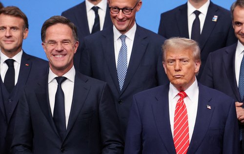 FILE PHOTO: U.S. President Donald Trump stands next to NATO Secretary General Mark Rutte as NATO leaders pose for a group photo at a NATO summit in The Hague, Netherlands June 25, 2025. REUTERS/Claudia Greco/File Photo