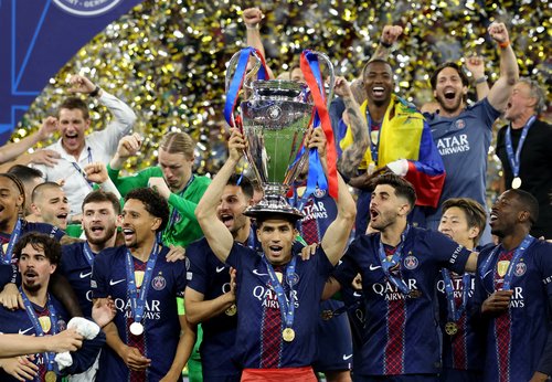 Soccer Football - UEFA Champions League - Final - Paris St Germain v Arsenal - Puskas Arena, Budapest, Hungary - May 30, 2026 Paris St Germain's Achraf Hakimi with the trophy as he celebrates with players after winning the UEFA Champions League REUTERS/Ph