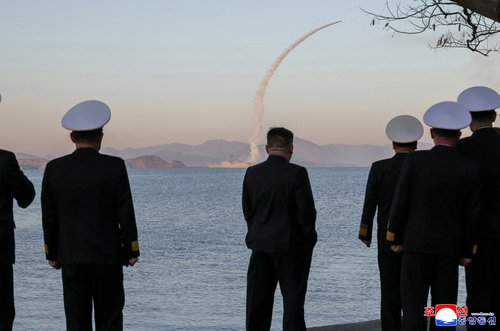 North Korean leader Kim Jong Un observes as strategic cruise missiles and anti-warship missiles are test-fired