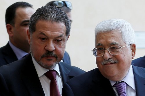 Palestinian President Mahmoud Abbas, accompanied by his son Yasser