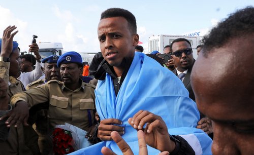 Somali referee Omar Abdulkadir Artan, who had been expected to officiate at matches during the 2026 FIFA World Cup but was denied entry to the United States, is received as he arrives at the Aden Abdulle Osman International Airport in Mogadishu, Somalia J