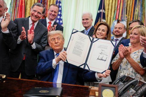 U.S. President Donald Trump holds up the Secure America