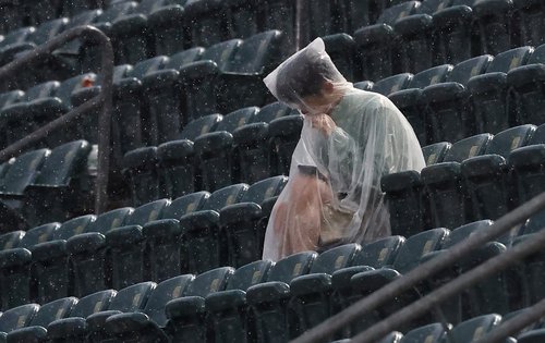 Soccer Football - FIFA World Cup 2026 - Group I - France v Iraq - Philadelphia Stadium, Philadelphia, Pennsylvania, U.S. - June 22, 2026 A fan in a poncho sits in the stands after a weather warning was displayed on the big screen as the second half is del
