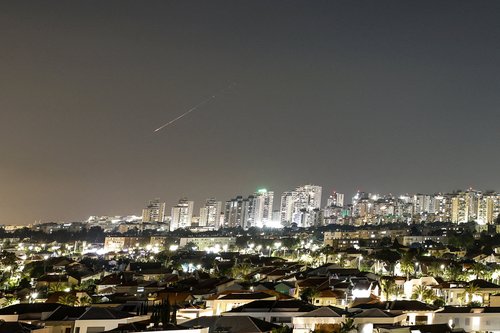 A streak of light illuminates the sky during a missile attack