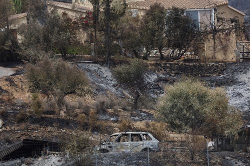 A charred car lies in a burned area following deadly wildfires affecting Almeria province, in Los Gallardos, Almeria, Spain, July 11, 2026. REUTERS/Violeta Santos Moura