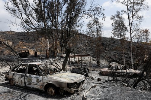 A charred, parked car remains in a burned area in the proximity where authorities believe deadly wildfires affecting Almeria province started, in Almocaizar, Almeria, Spain, July 12, 2026. REUTERS/Violeta Santos Moura