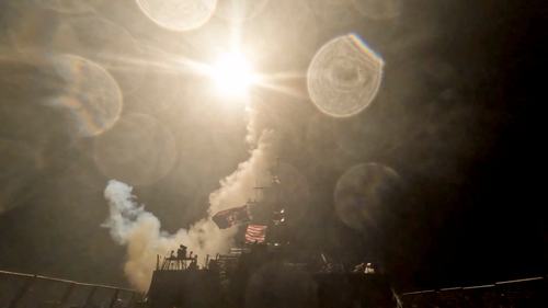 A U.S. warship launches a munition at an unknown location during