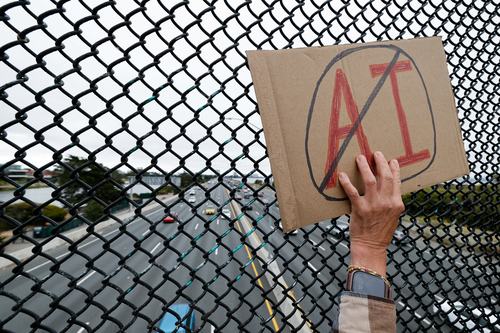 A woman displays a sign as demonstrators participate in nationwide protests against data centers, in Berkeley, California, U.S., July 18, 2026. REUTERS/Fred Greaves