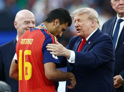 Soccer Football - FIFA World Cup 2026 - Final - Spain v Argentina - New York/New Jersey Stadium, East Rutherford, New Jersey, U.S. - July 19, 2026 Spain's Rodri receives his winners medal from U.S. President Donald Trump during the trophy ceremony REUTERS