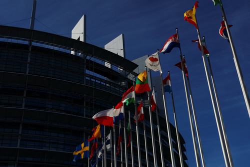 Flags flutter near the European Parliament building