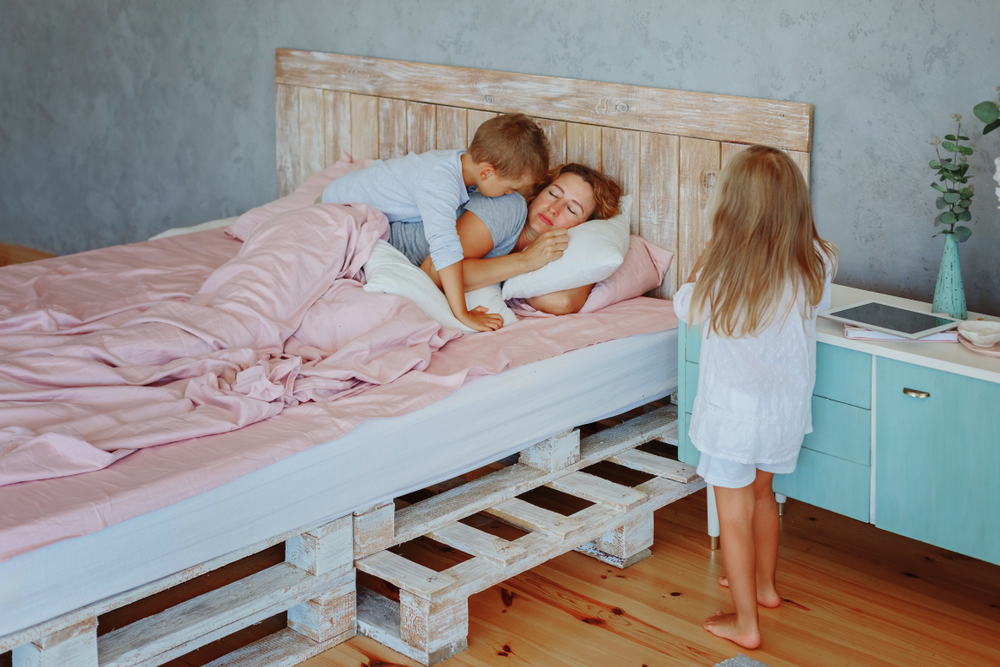 Son,And,Daughter,Try,To,Wake,Up,Their,Tired,Mother