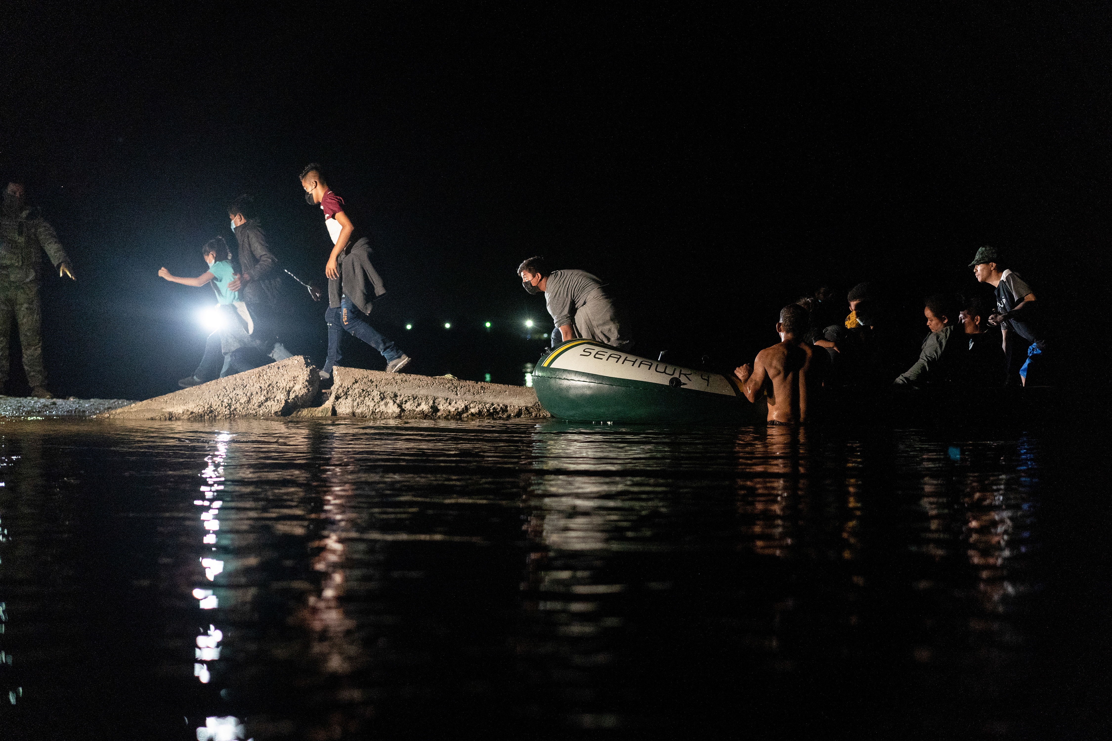 Asylum-seeking migrants cross the Rio Grande river in Roma