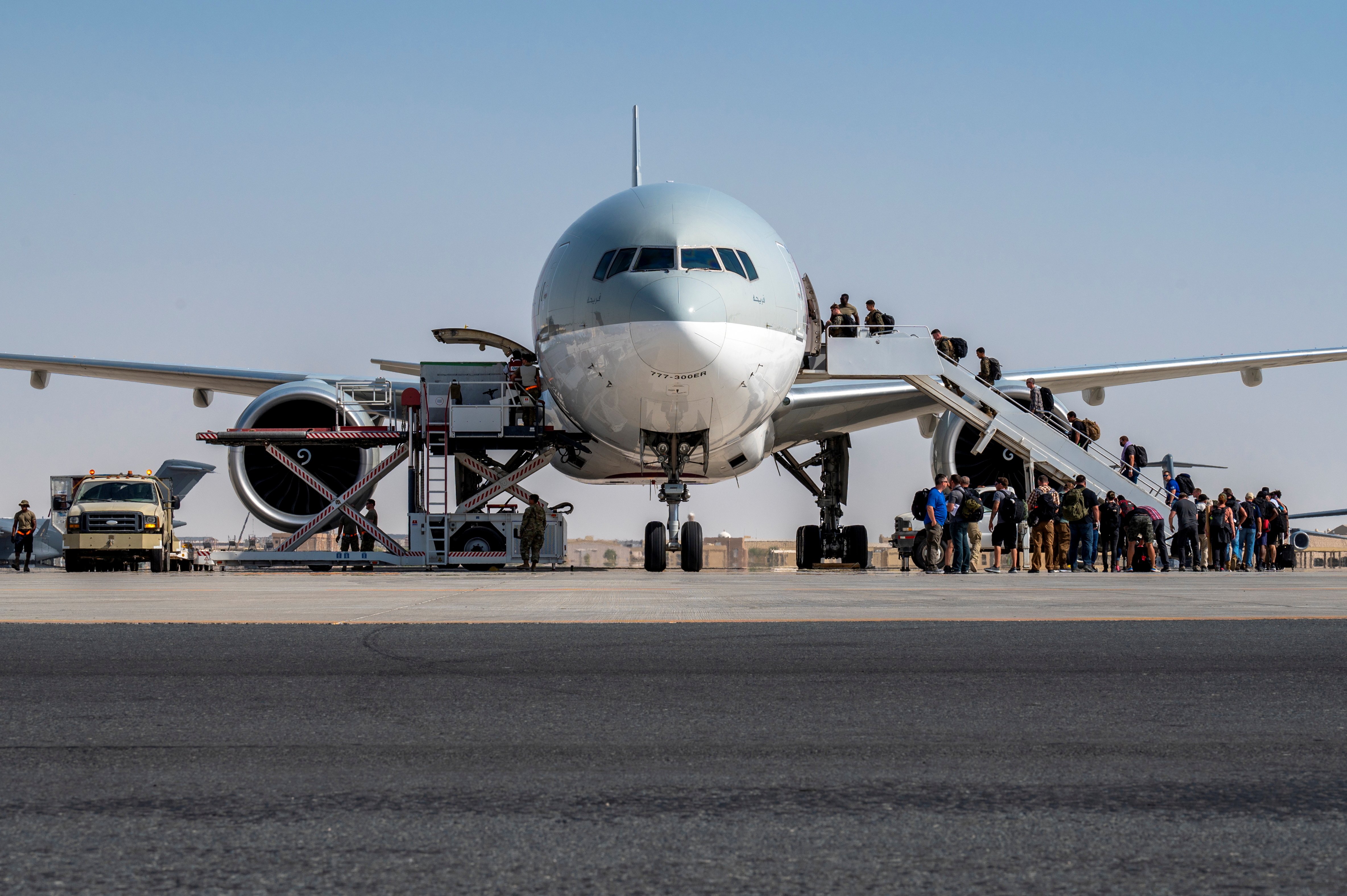 FILE PHOTO: U.S. Embassy personnel from Afghanistan board a Qatar Airways flight to Kuwait