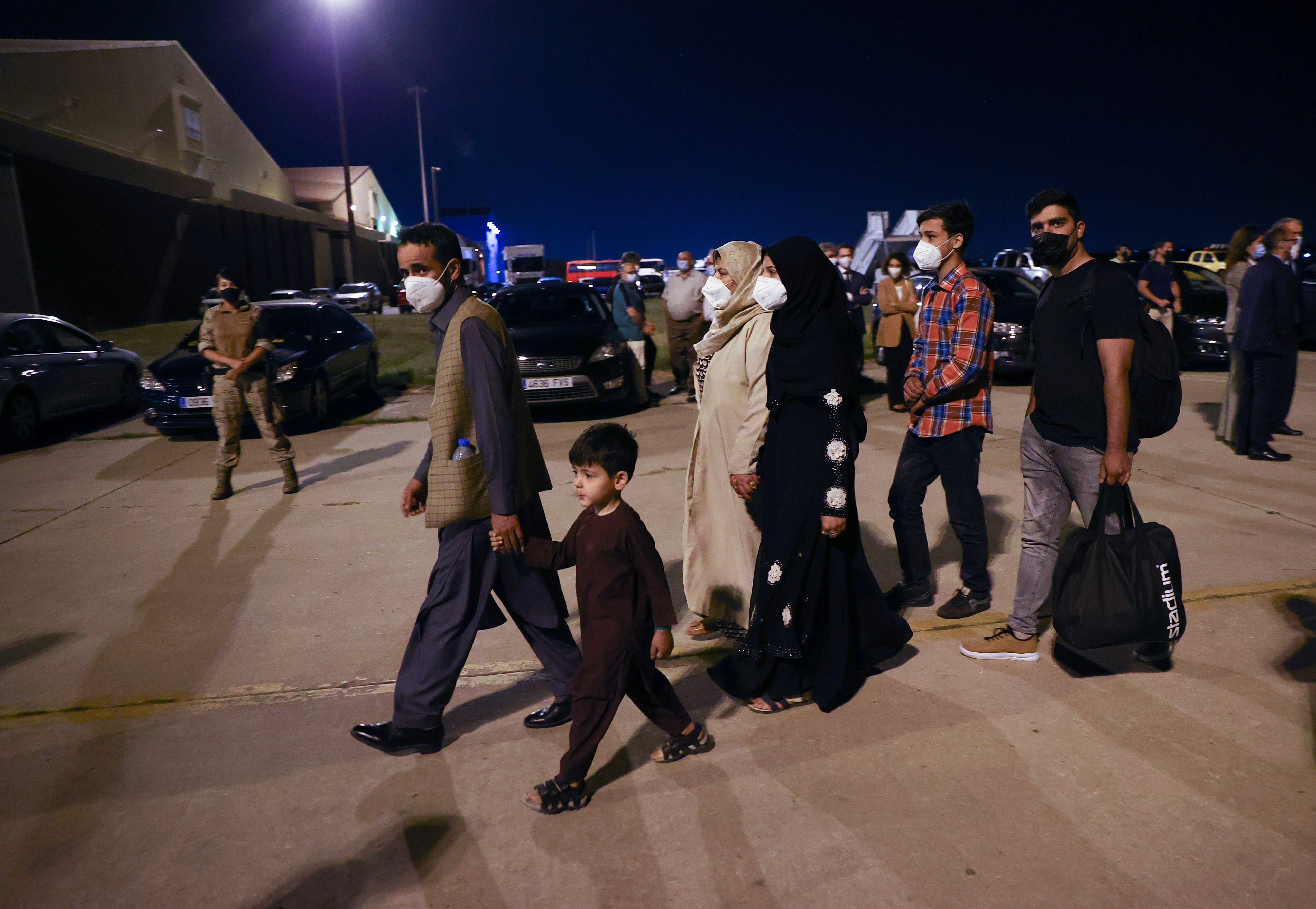 Spanish and Afghan citizens who were evacuated from Kabul arrive at Torrejon airbase in Torrejon de Ardoz