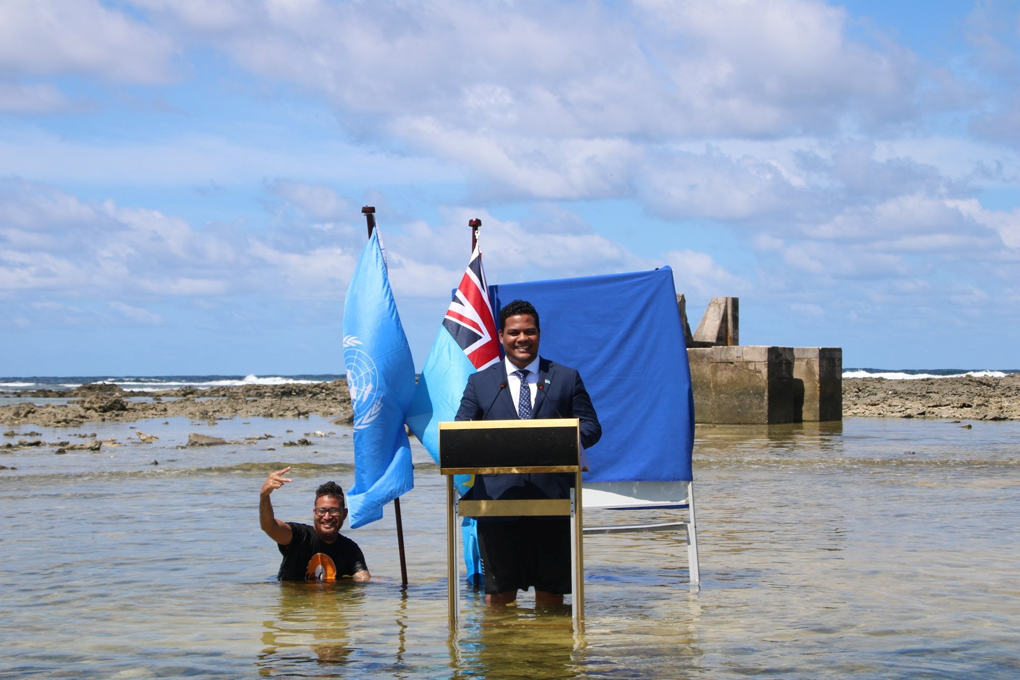 Tuvalu's Minister for Justice, Communication &amp; Foreign Affairs Simon Kofe gives a COP26 statement while standing in the ocean in Funafuti