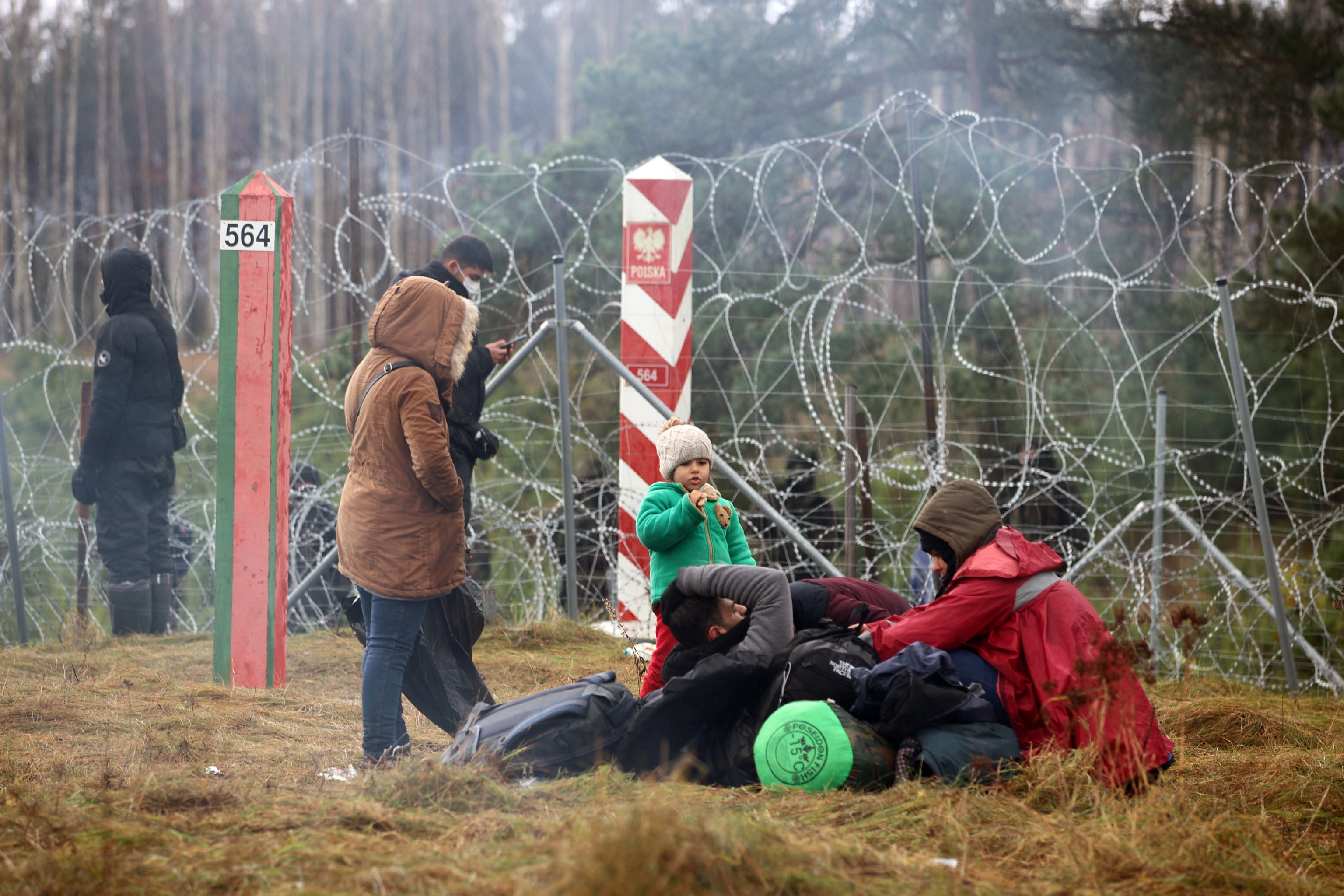 Migrants gather on the Belarusian-Polish border