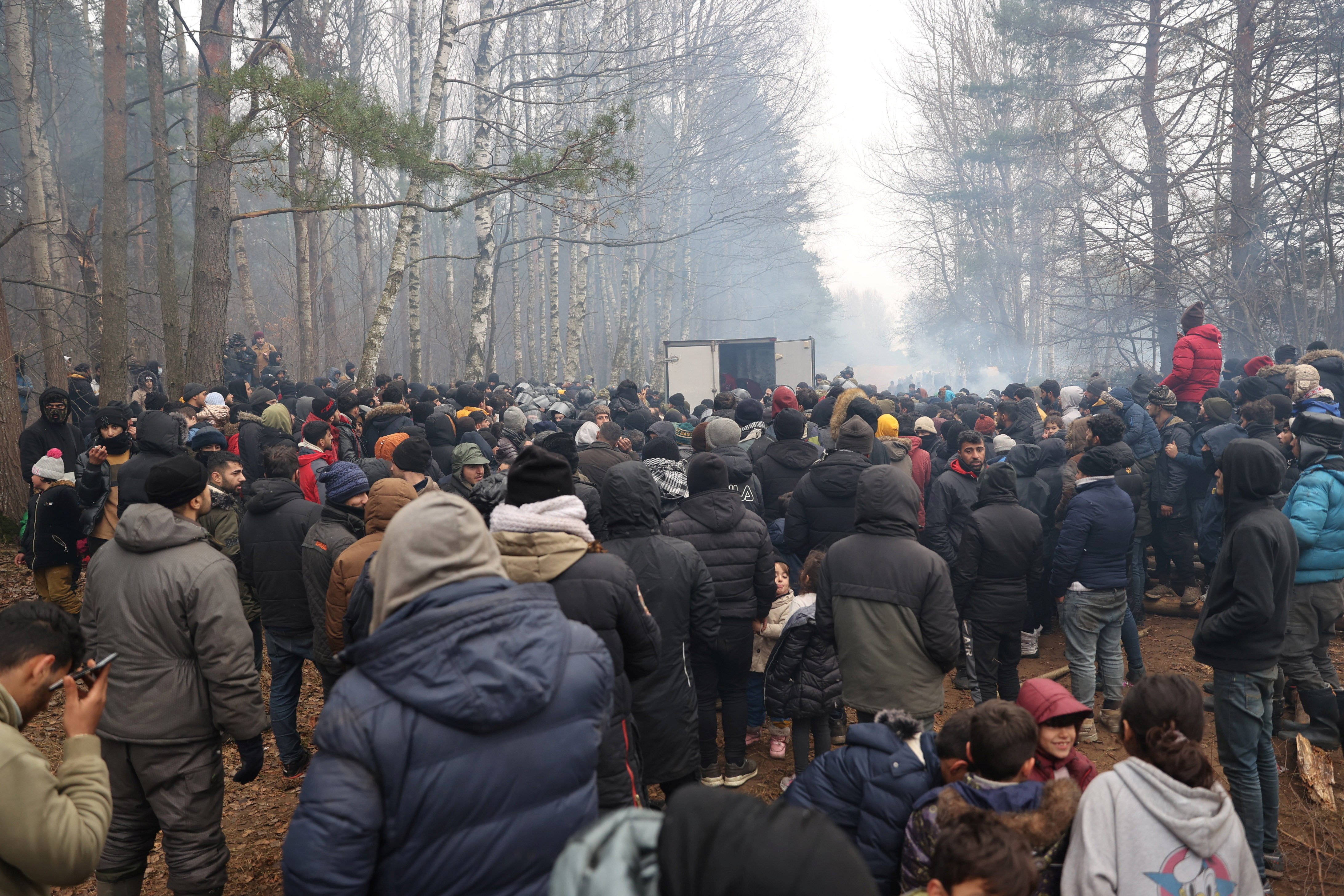 Migrants gather on the Belarusian-Polish border