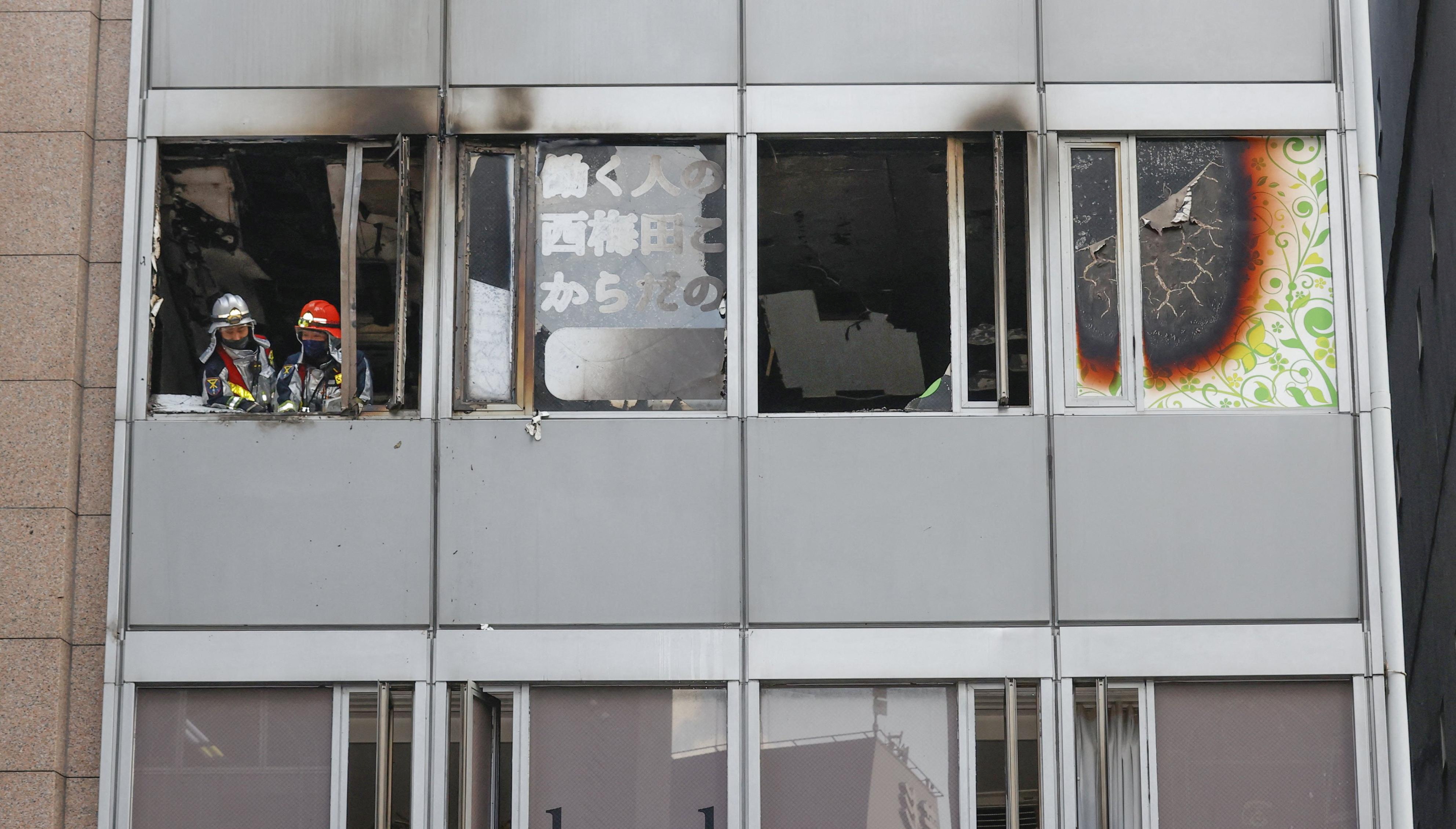 Firefighters are seen at a building where a fire broke out in Osaka