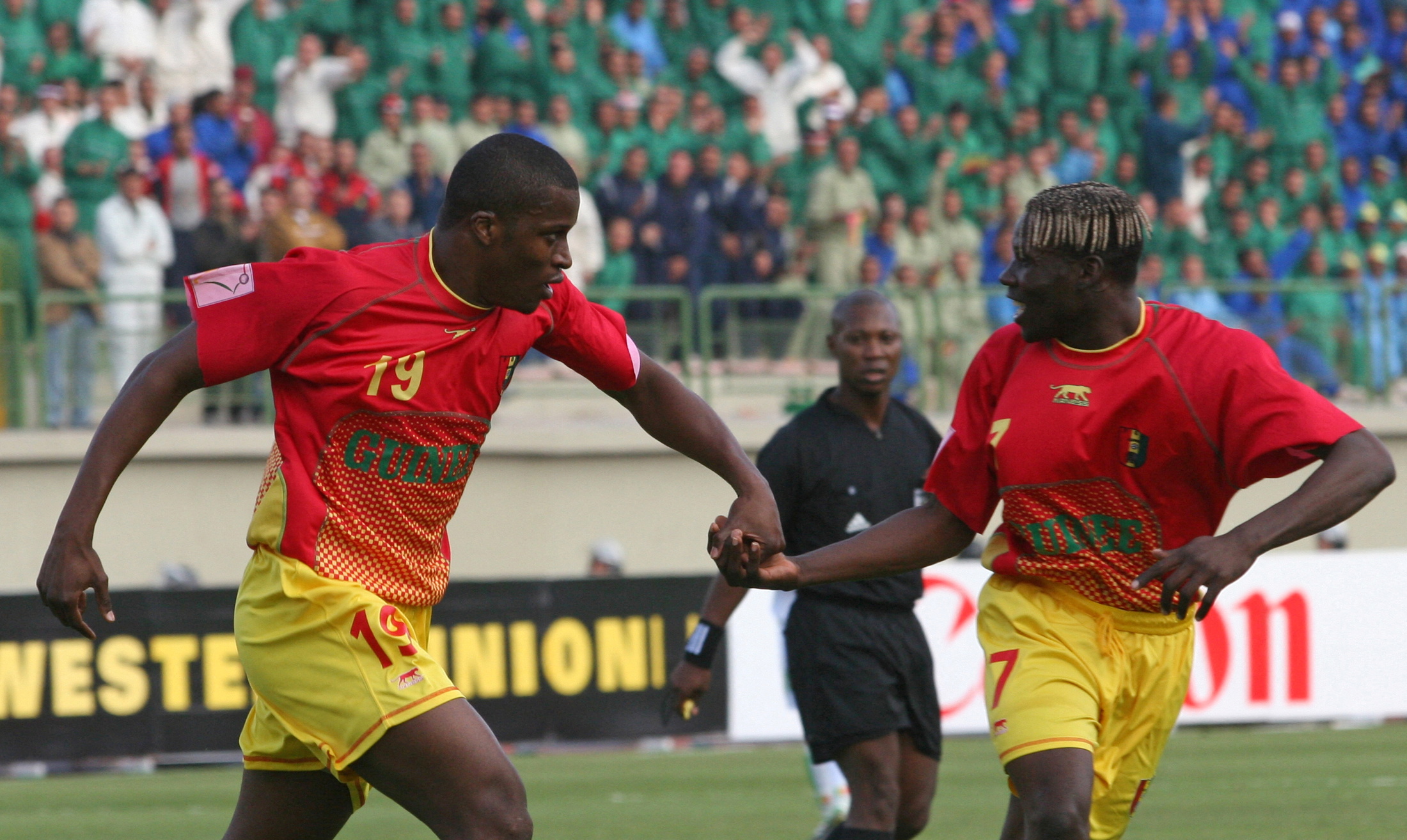 FILE PHOTO: Guinea's Diawara celebrates his goal with team mate Mansare during African Nations Cup in Egypt