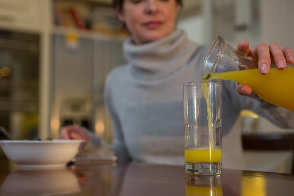 Woman pouring juice in glass