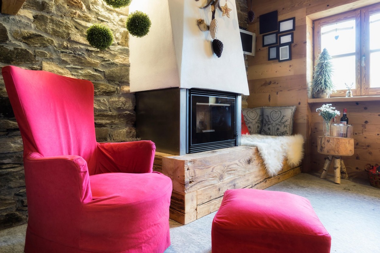 Cozy interior of a rustic chalet with modern fireplace