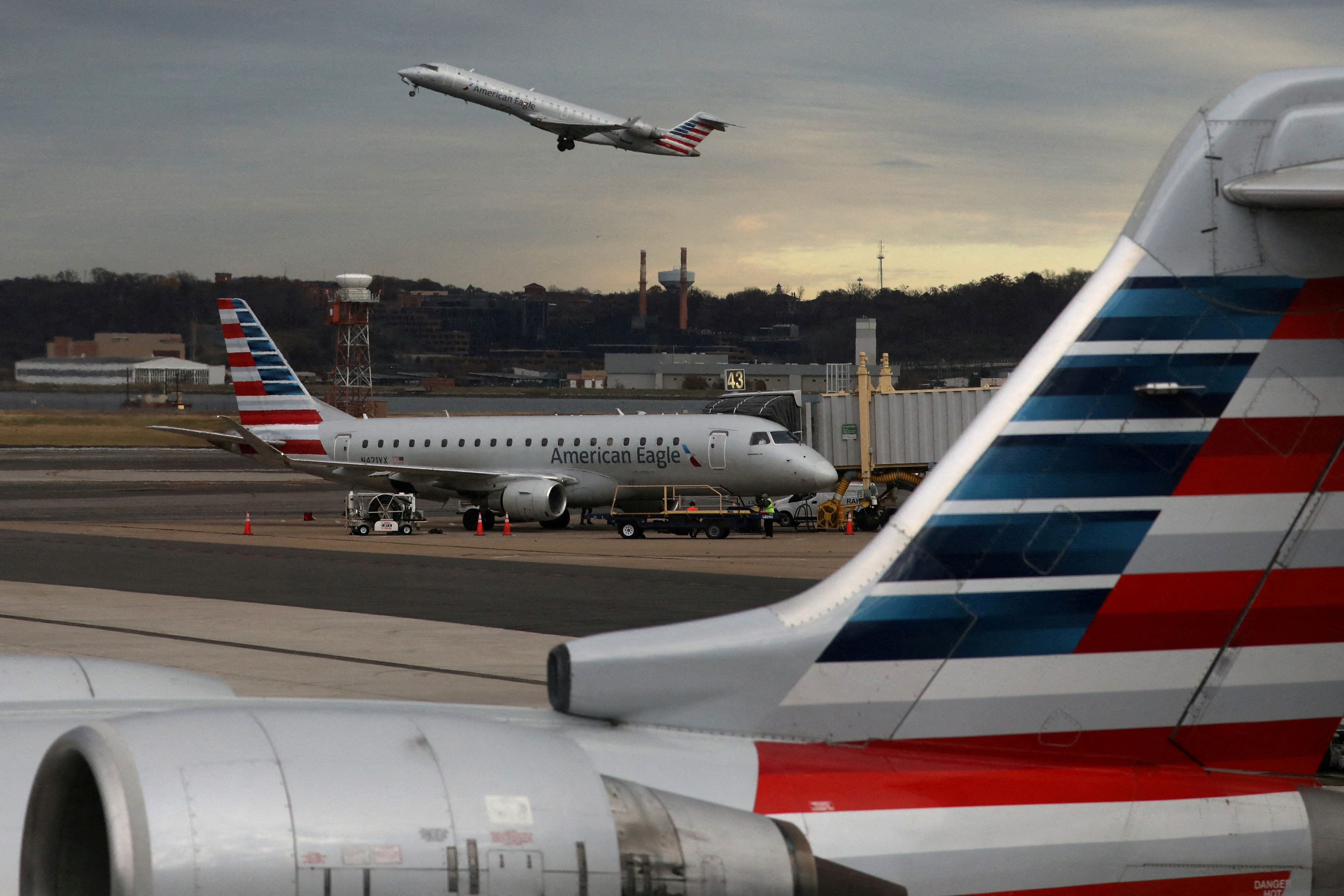 FILE PHOTO: A jet from American Eagle, a regional branch of American Airlines (AA), takes off past other AA aircraft at Ronald Reagan Washington National Airport in Arlington