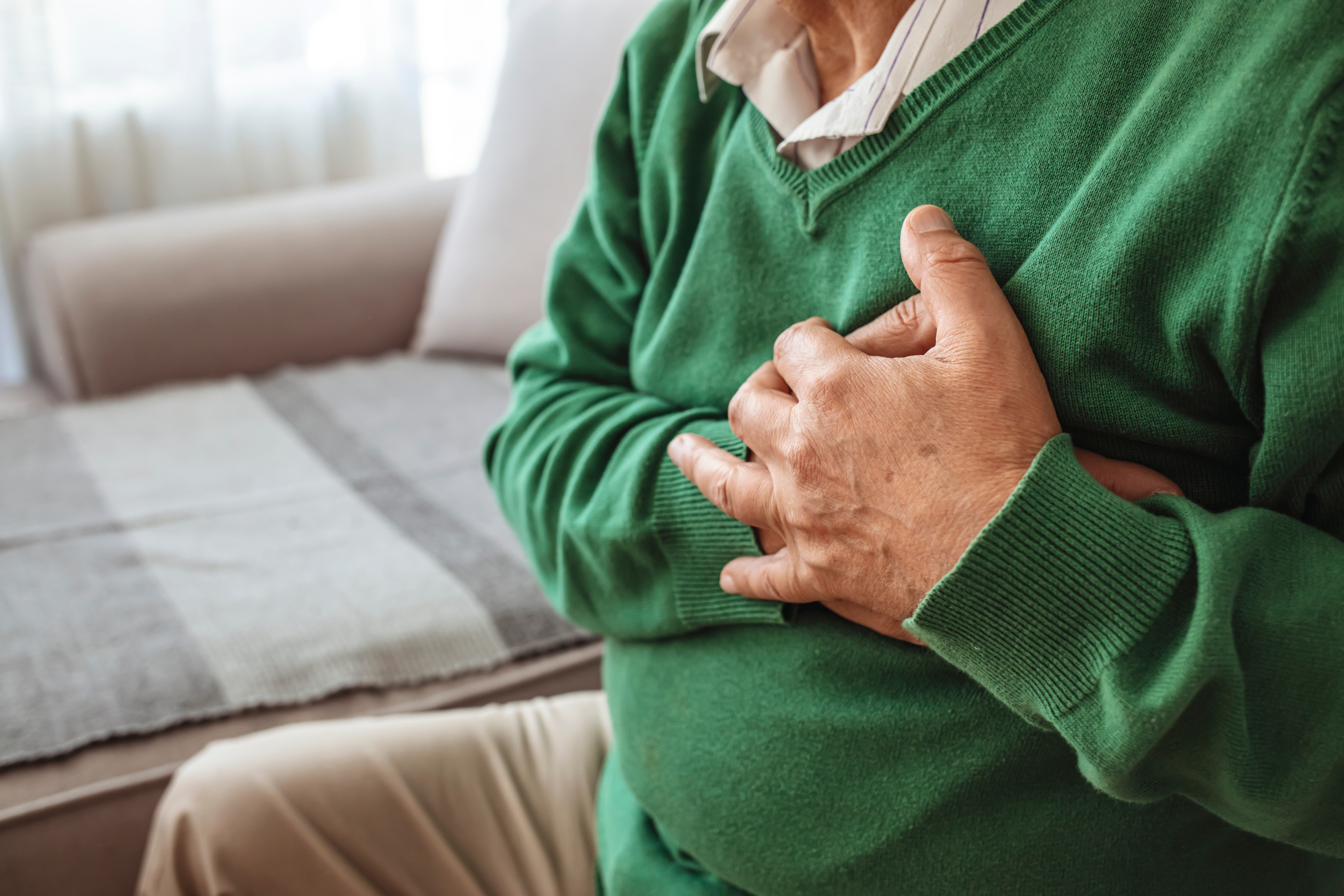 Senior,Man,Suffering,From,Heart,Attack,At,Home.,Man,Clutching